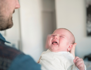 baby-crying-while-dad-holds-them-new-father-soothing.jpg