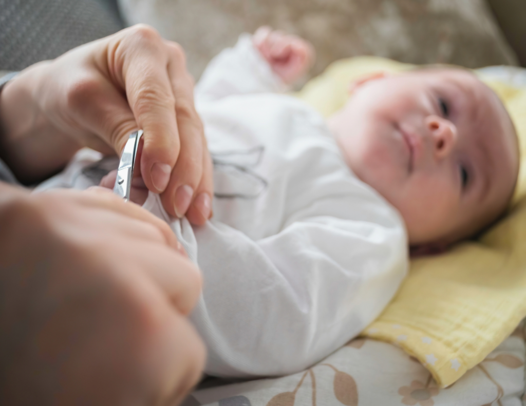 A calm, relaxed baby makes nail trimming much easier — if your baby is content and still, that's your window. SEO description: Photo of a parent holding baby nail clippers and trimming the hand of a calm, awake infant dressed in a white onesie and lying on a yellow blanket, showing a real-life example of safe at-home baby nail care.  This image works well paired with the "Pick the right moment" step in the article since the baby is visibly calm and awake — it shows parents that trimming doesn't have to happen only during sleep. It also gives good visual contrast to the toenail scissors photo, since this one features clippers and a fingernail. Use this one in the trimming steps section and the toenail photo lower down near the FAQ.You said: i will use this image for a blog name the image and give me the alt text caption and description for seo.i will use this image for a blog name the image and give me the alt text caption and description for seo.9:33 PMClaude responded: Here you go:Here you go:  File name: baby-nail-scissors-blue-rounded-tip-finger-trimming.jpg Alt text: A parent using blue rounded-tip baby nail scissors to trim a baby's fingernail while holding the hand steady Caption: Baby scissors with rounded tips give you more control than clippers — especially useful for newborns with very small fingers. SEO description: Close-up photo of a parent firmly holding a baby's small hand while using blue rounded-tip baby nail scissors to trim a fingernail, with colorful baby toys softly blurred in the background, demonstrating proper baby nail trimming technique.  This is your most instructional image of the three nail trimming shots — it clearly shows the recommended tool (rounded-tip scissors), the two-handed grip, and the scale of a baby's fingers up close. It works best placed right inside the "What You'll Need" or "Step 3: Trim" section of the article. The blurred toys in the background also give it a natural, lived-in feel rather than a staged look.You said: i will use this image for a blog name the image and give me the alt text caption and description for seo.i will use this image for a blog name the image and give me the alt text caption and description for seo.9:35 PMClaude responded: Here you go:Here you go:  File name: parent-trimming-sleeping-baby-fingernails-pink-clippers.jpg Alt text: A parent trimming the fingernails of a sleeping newborn in a white outfit using small pink baby nail clippers Caption: Trimming during sleep is the easiest approach for most newborns — they stay still and you get a clear view of each nail. SEO description: Photo of a parent holding a sleeping newborn's small hand and trimming the fingernails with pink baby nail clippers, while the baby lies still in a white and pink outfit on a soft blanket, illustrating the sleep trimming method for infant nail care.  This is the strongest practical image of the set because it directly shows the most recommended tip in the article — trimming during sleep. Place it alongside the "Trim during sleep" tip or at the top of the trimming steps section. It also adds representation with a dark-haired newborn, which pairs well with the cradle cap article's note about how skin conditions can look different across skin tones.